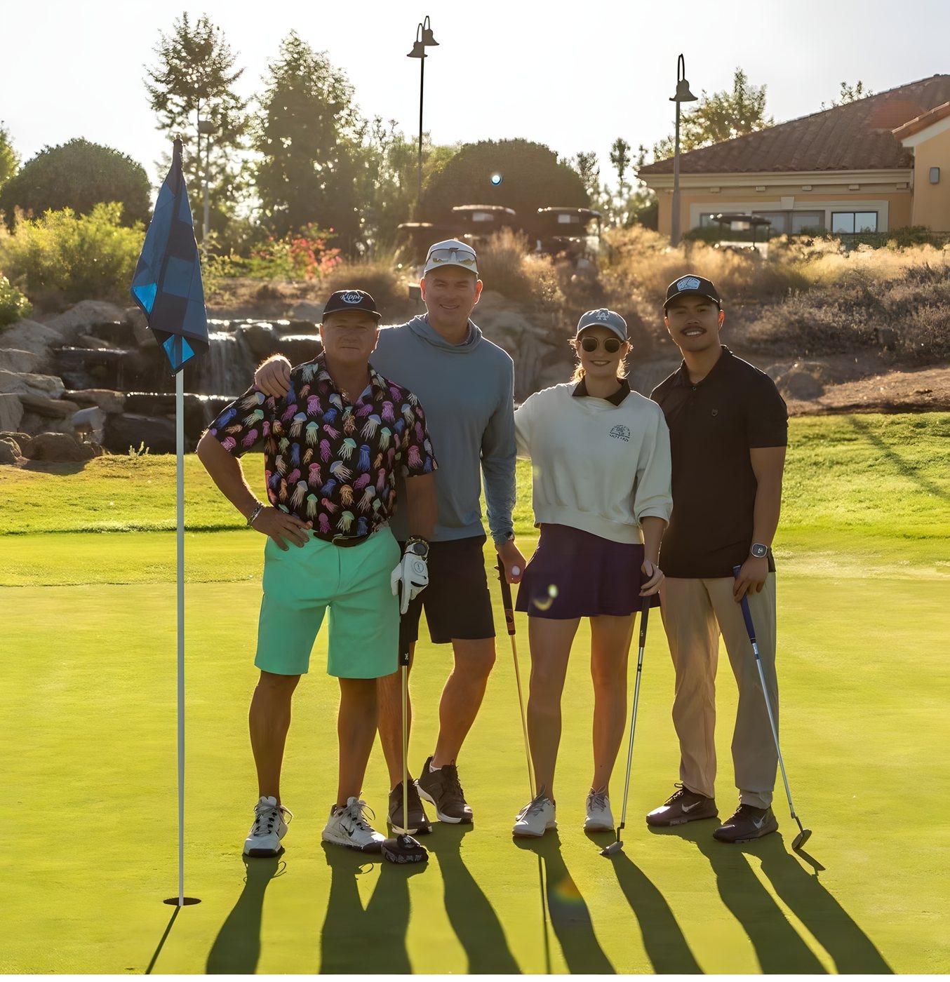 A foursome posing at the flagstick after finishing a hole