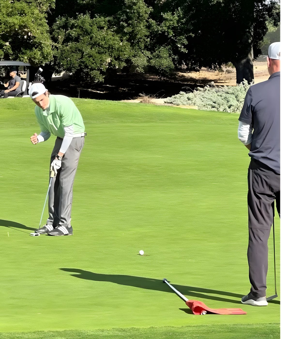 Players lining up putts on the green