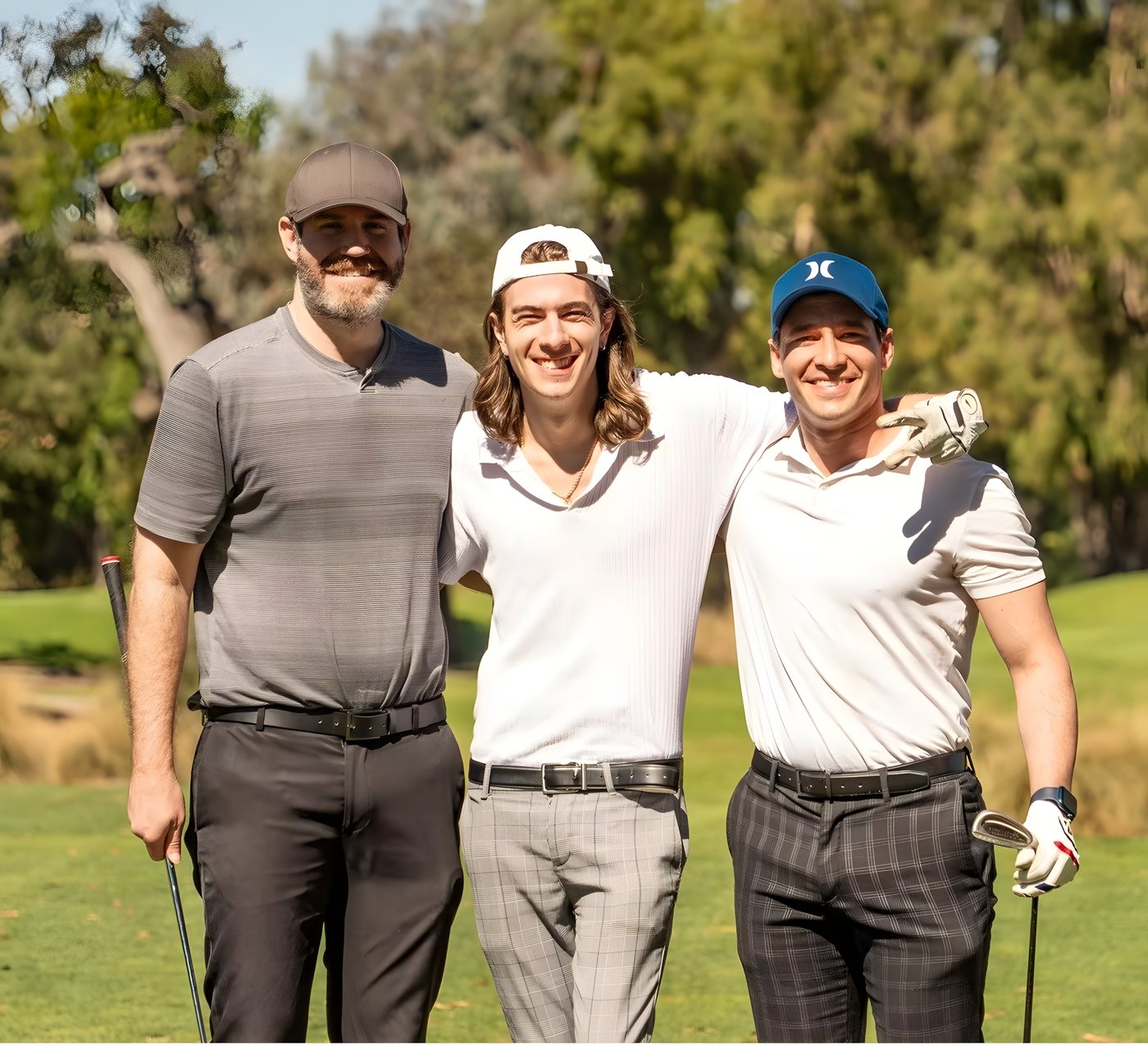 Three golfers posing together during the round