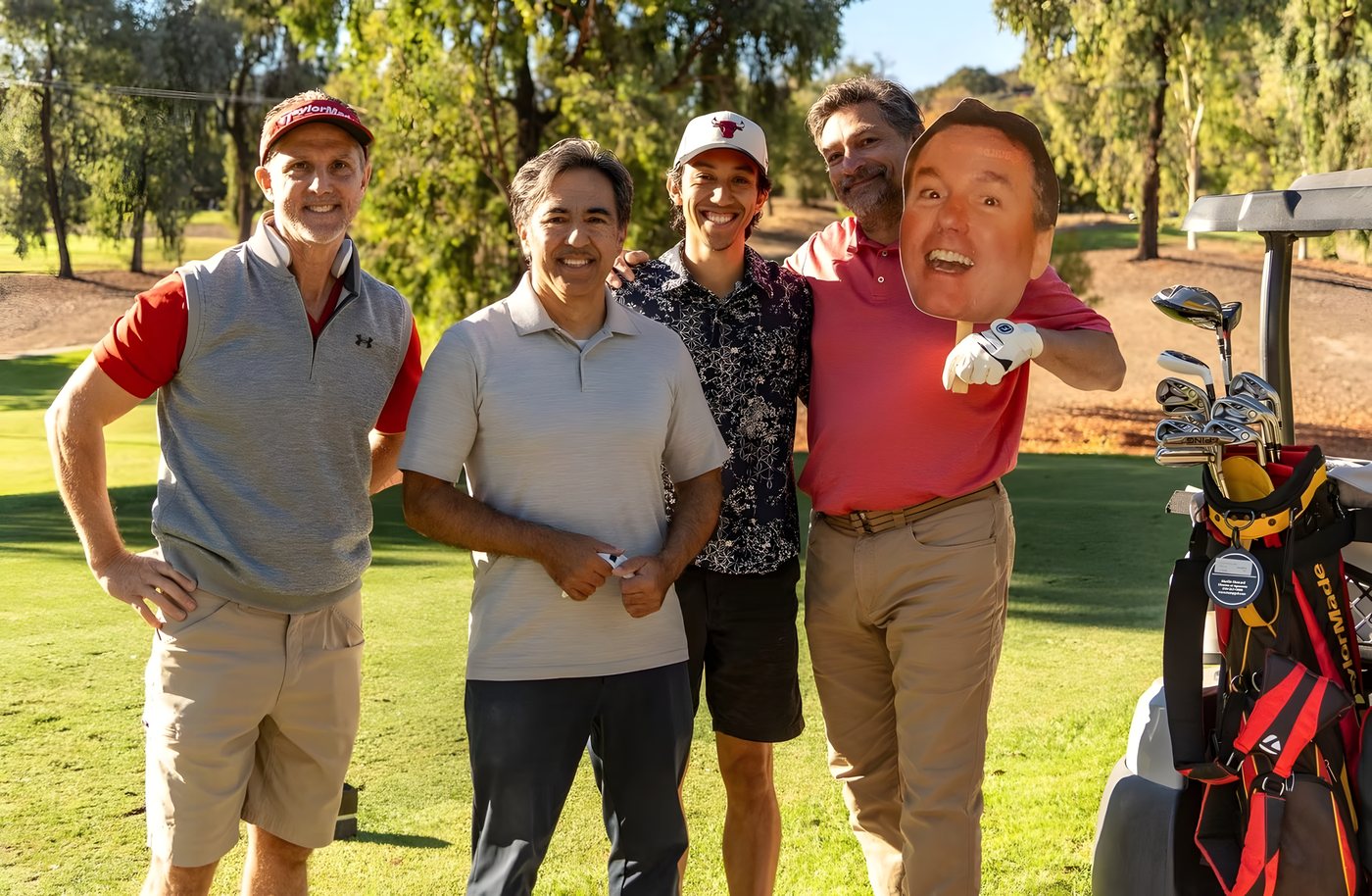 A team posing with a Kipper cutout beside the cart