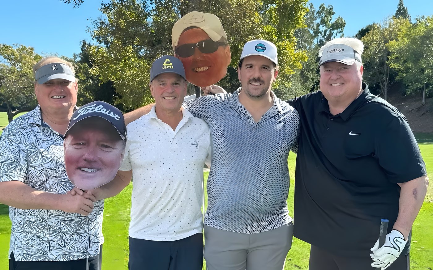 A foursome posing with a Kipper cutout on the fairway