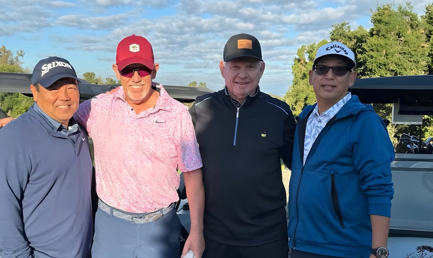 Four golfers lined up for a team photo