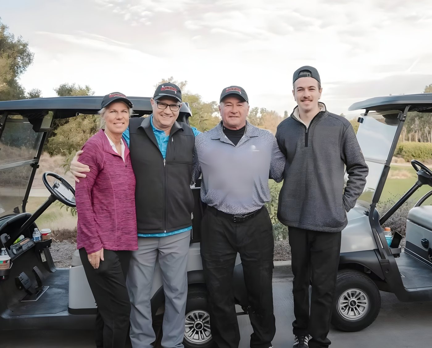 Four players posing in front of their carts
