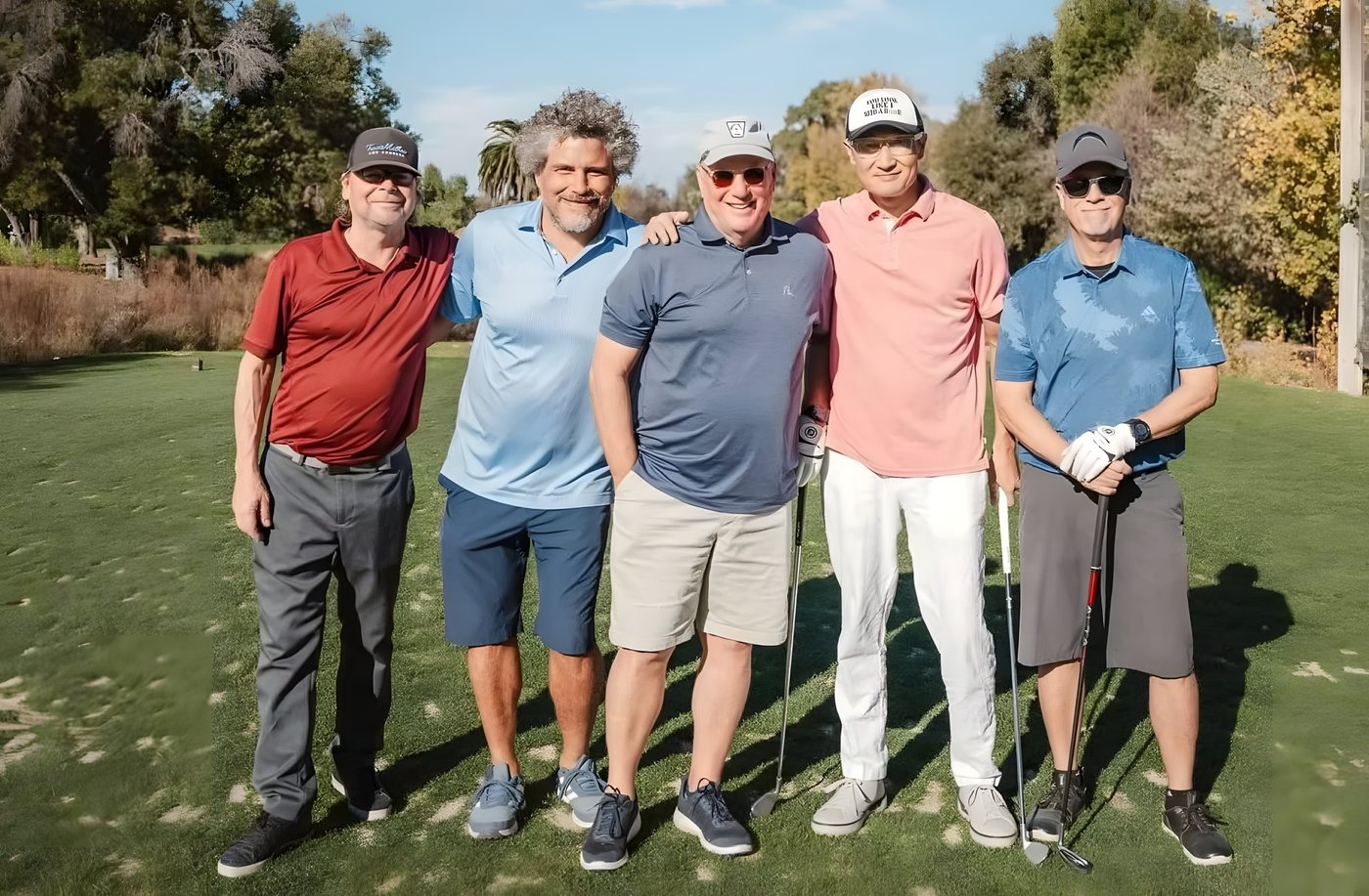A group of players posing together on the fairway