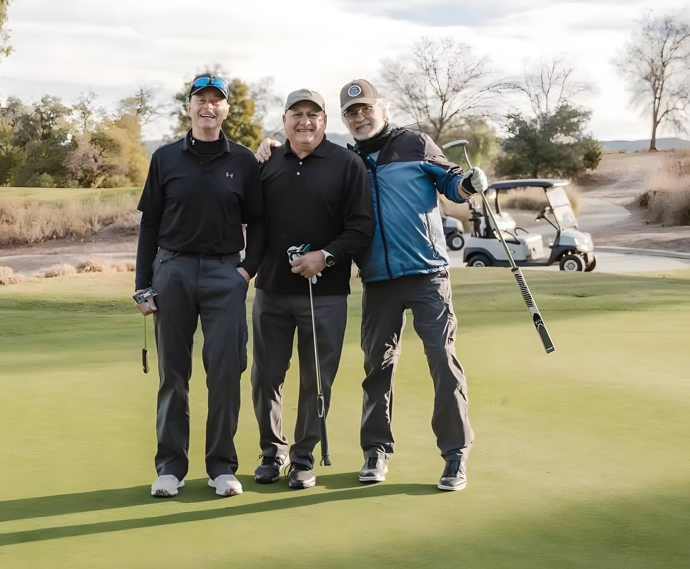 Four golfers posing on the green