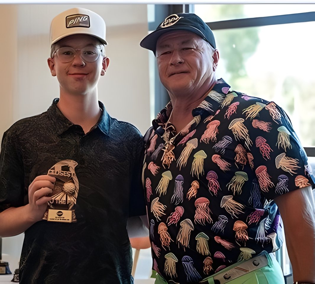 A young winner with his award alongside the tournament host